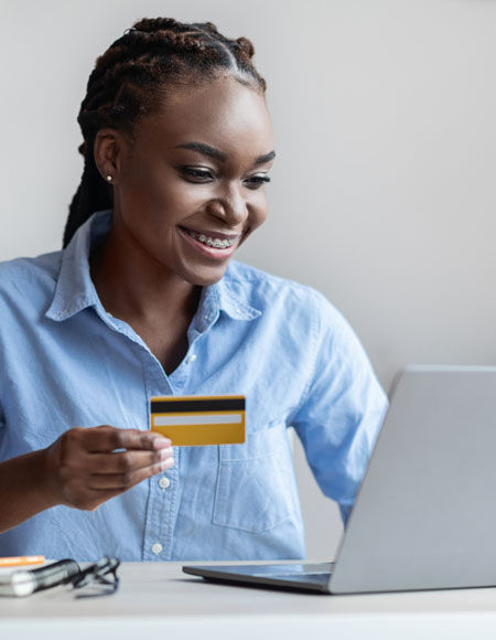 Young woman making an online purchase with a credit card