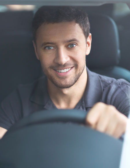 Young man behind the wheel of a car